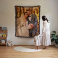 Custom woven photo blanket of a wedding portrait hung on a living room wall while a mother and daughter look up at it